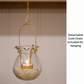 T Light Candle Holder and Lantern for Diwali and festive season. It can be used as Glass Urli for flower decoration. It has gold accent chain as well.