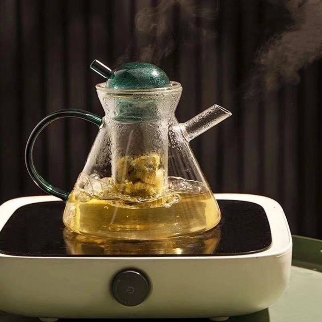 Elegant transparent and green glass teapot set on office desk
