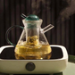 Elegant transparent and green glass teapot set on office desk
