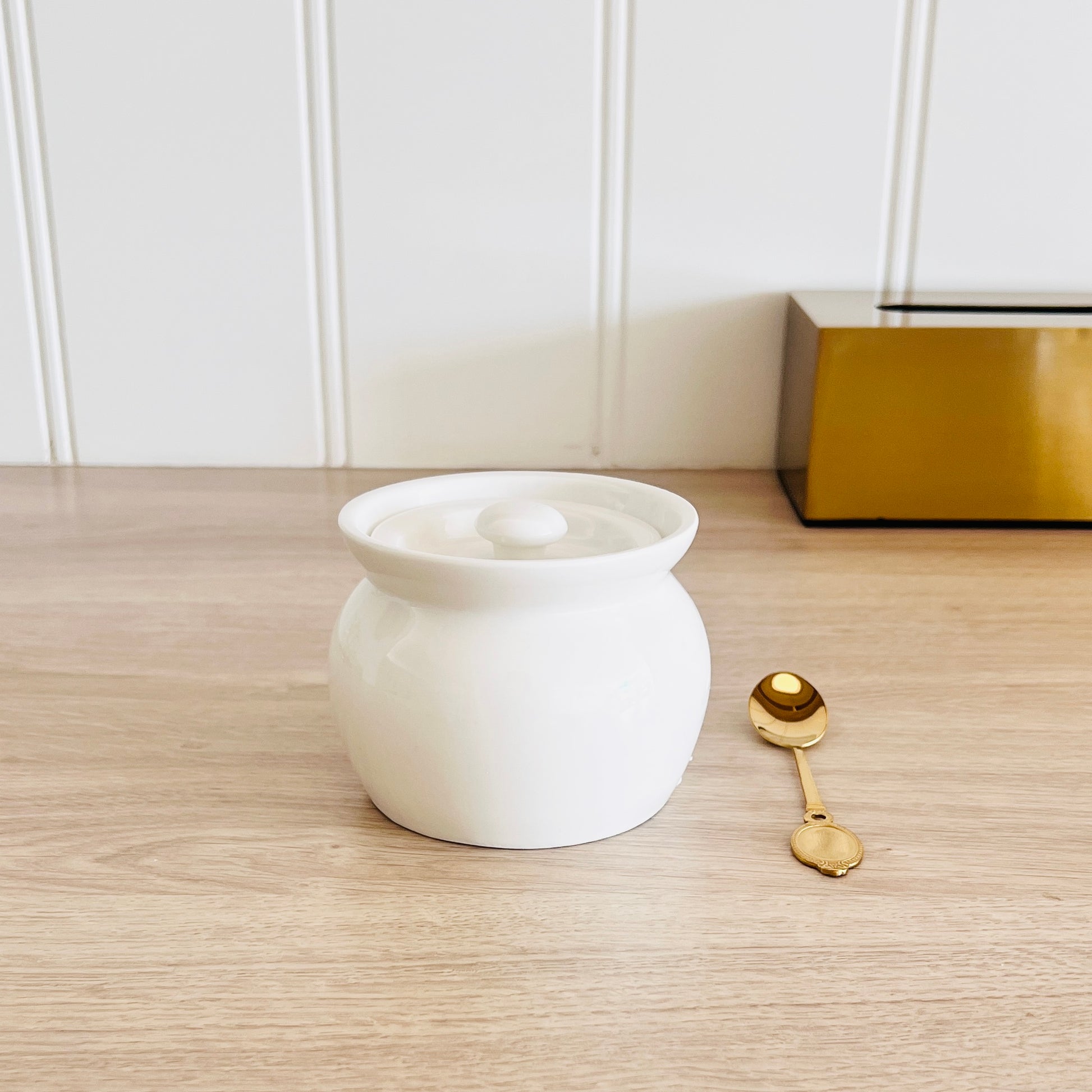 White ceramic ghee pot with lid and gold spoon – luxury kitchen storage jar