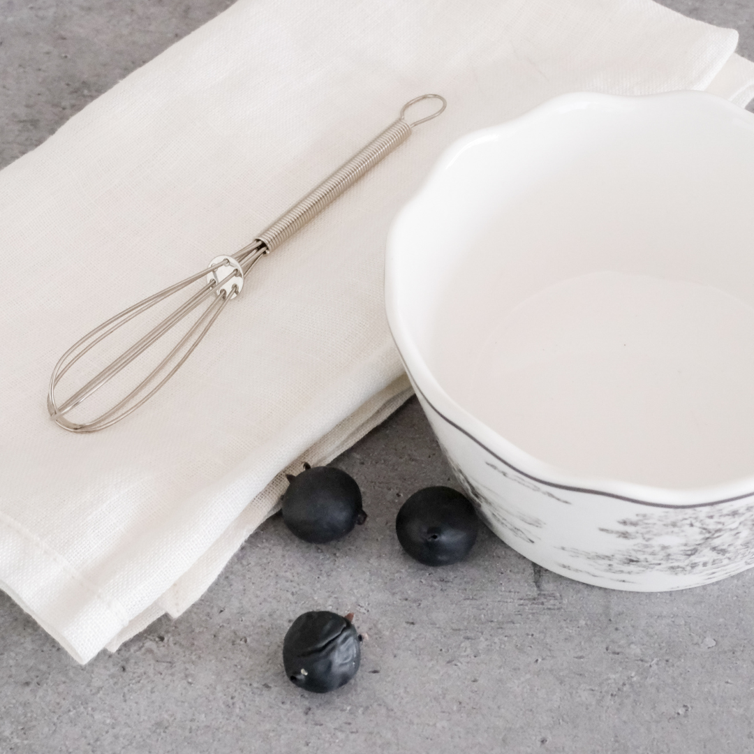 	Elegant mini whisk displayed as a stylish kitchen countertop accessory