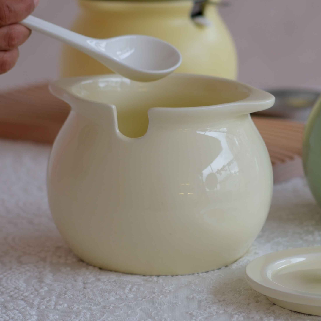 Large ceramic storage bowl with spoon and filter for everyday use.