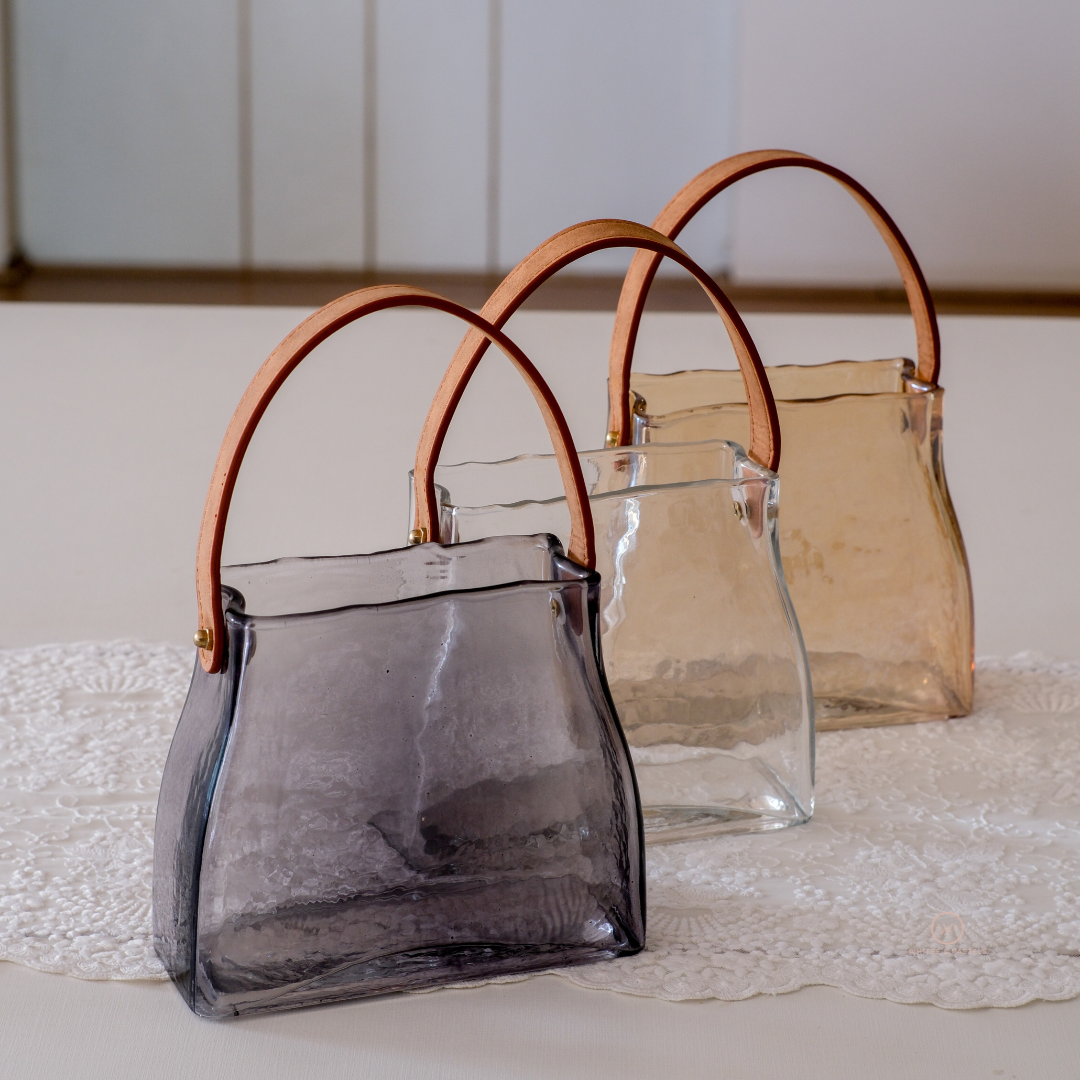 Luxury glass beverage jar with hammered texture and premium leather handle.