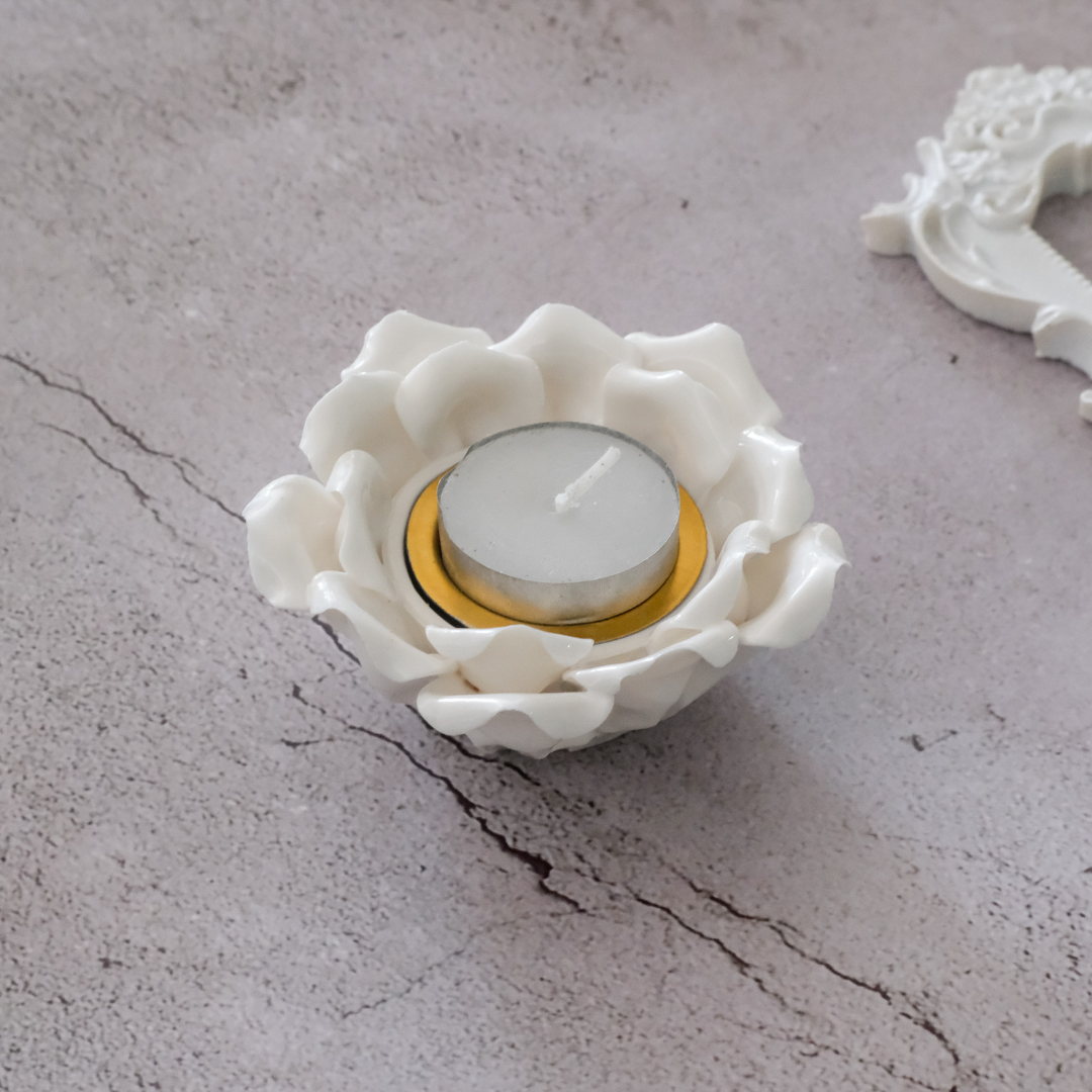 White ceramic lotus candle holder styled as a dining table centerpiece
