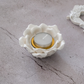 White ceramic lotus candle holder styled as a dining table centerpiece
