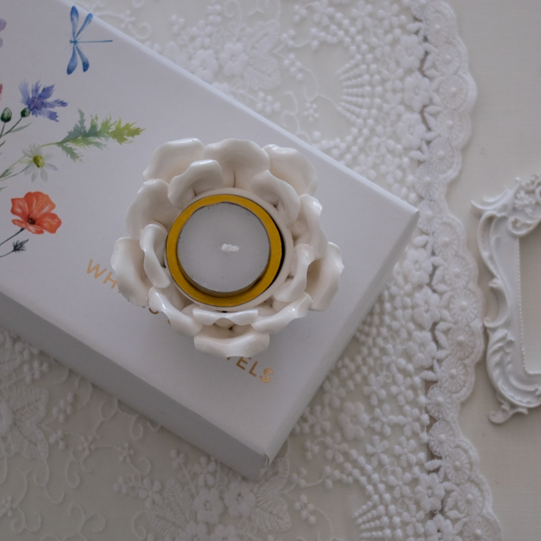 White lotus tea light holder creating a warm bedroom ambience