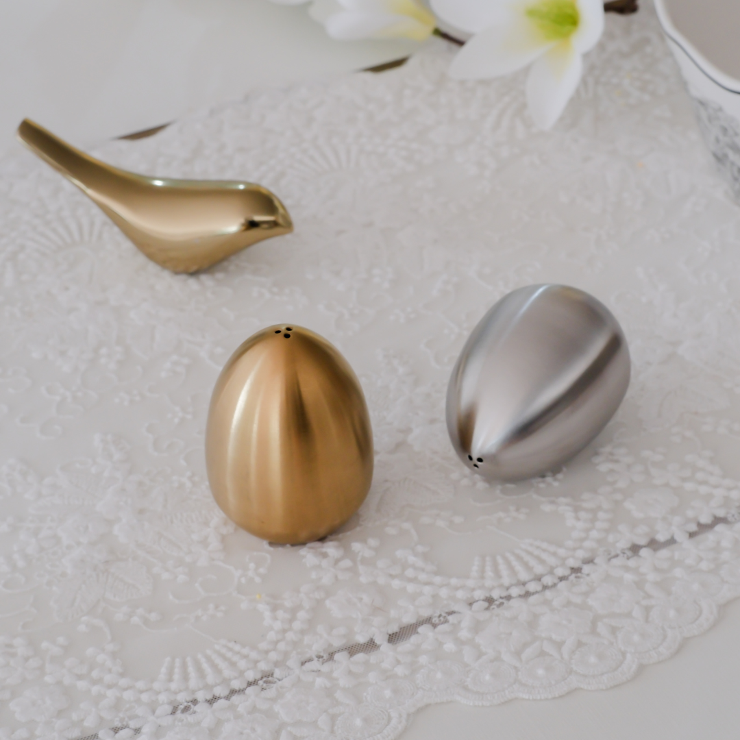 Contemporary dining accessory featuring egg-shaped salt and pepper shakers.