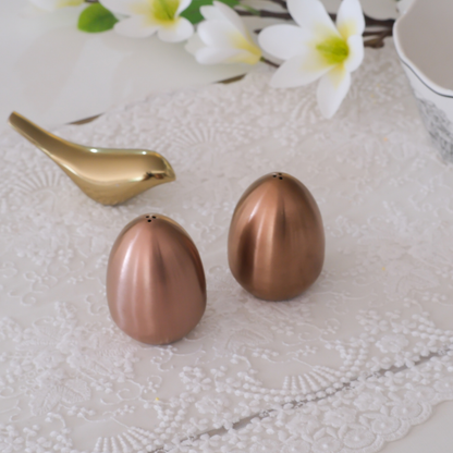 Elegant seasoning shaker pair with smooth brushed metal finish. Rose gold