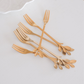 Modern gold fruit forks with elegant leaf design for everyday and festive dining