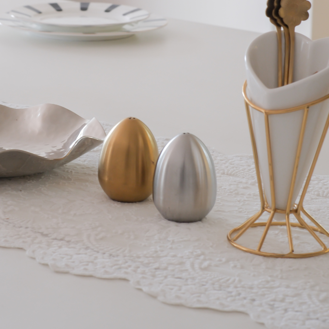 Modern kitchen table salt and pepper shakers in sculptural egg design.