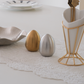 Modern kitchen table salt and pepper shakers in sculptural egg design.