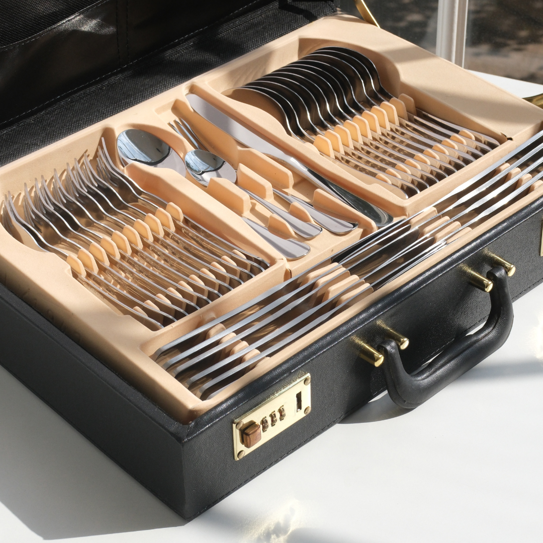 Collection of high quality cutlery such as Spoons, Forks and butter knife placed inside the black faux leather giftbox