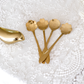 Elegant flower-inspired gold spoons with intricate carved textures, perfect for desserts and beverages.