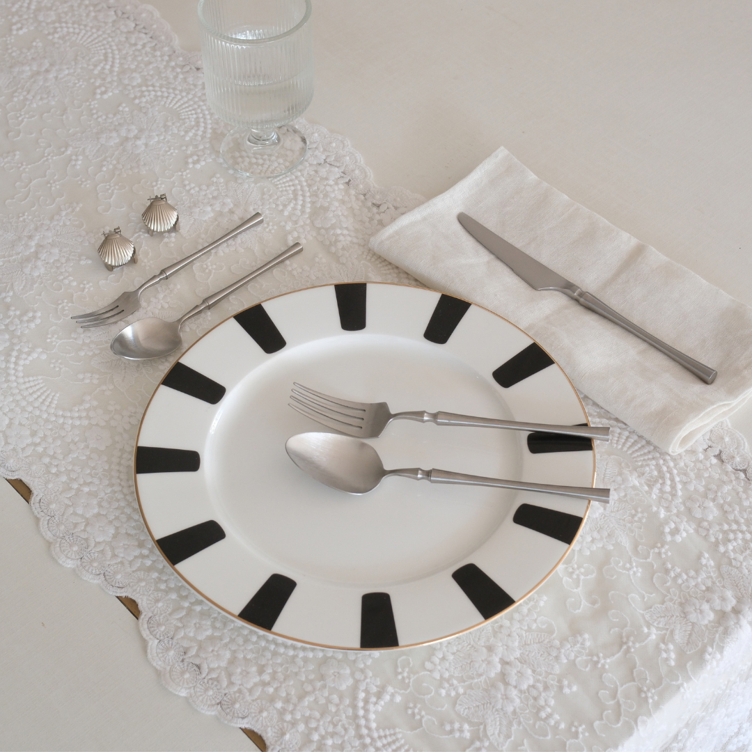 Set of 5 pc Silver Cutlery Set placed on Dining table on white runner