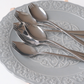 Luxury gold dessert sporks featuring a mirror finish and decorative bird spoon holder for stylish table settings.