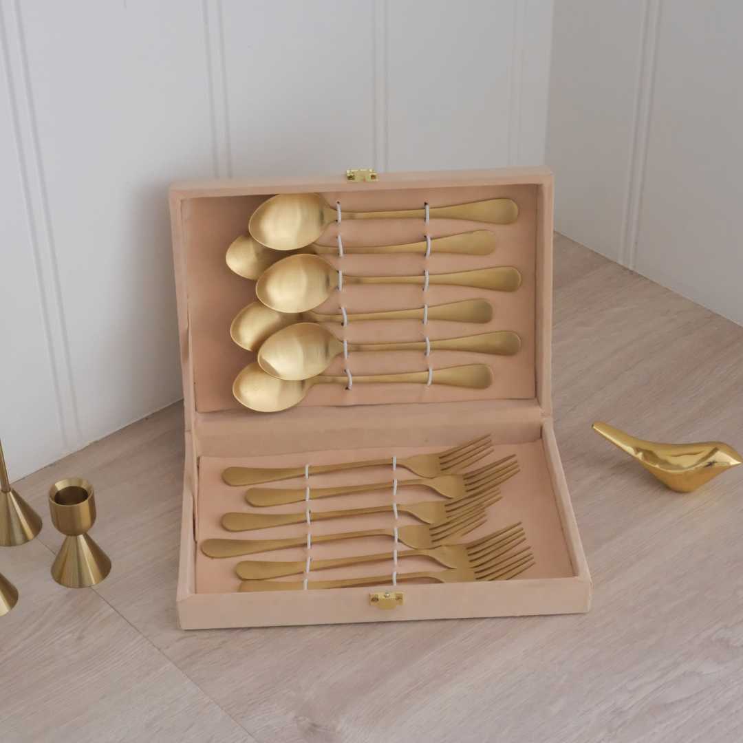 Beige giftbox with cutlery set on wooden counter