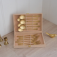 Beige giftbox with cutlery set on wooden counter