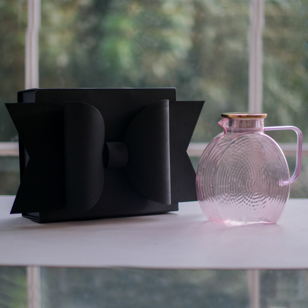 Luxury pink glass water jug featuring a gold lid and matching pink handle