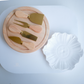 Luxury cheese serving platter with rotating wooden storage box and cheese accessories.