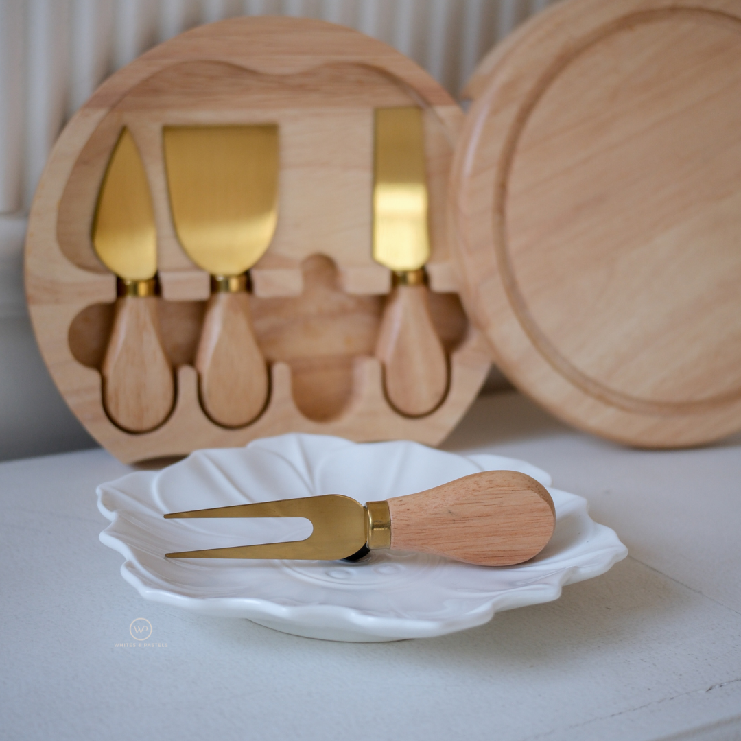 Premium charcuterie serving board with gold cheese knives and natural mango wood finish.