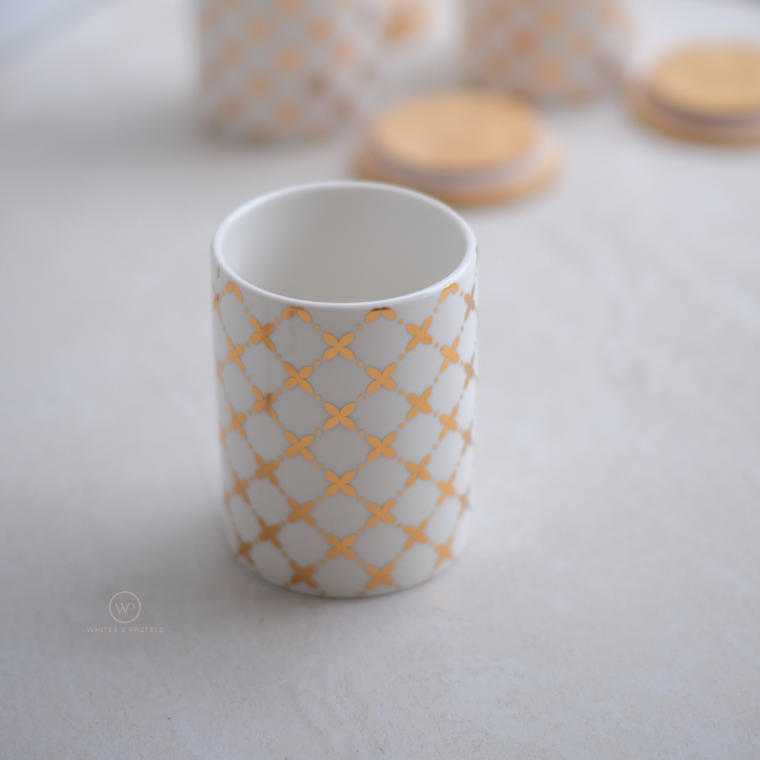 White ceramic kitchen storage containers with gold design