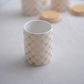 White ceramic kitchen storage containers with gold design