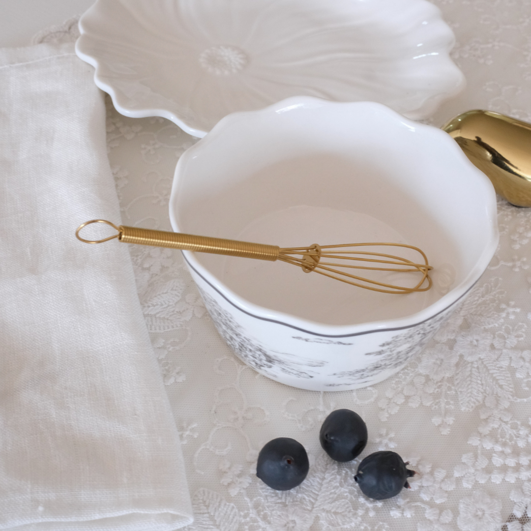 Stainless steel mini whisk featuring a hanging loop for easy storage