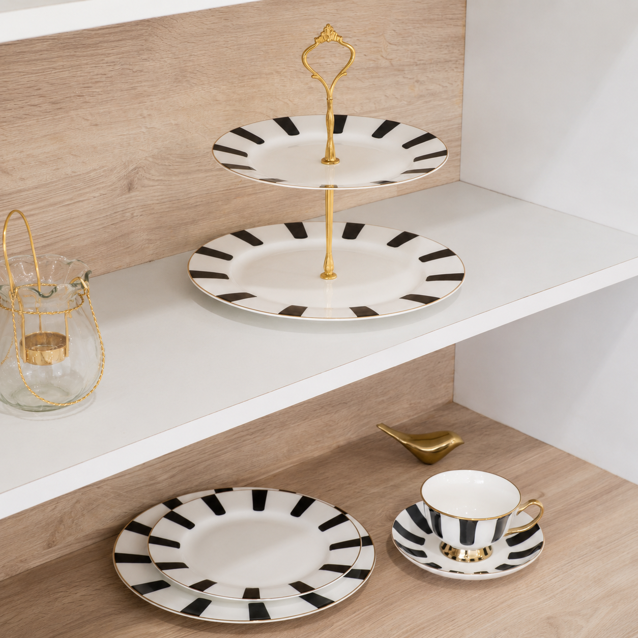 White ceramic dinner plate with bold black stripe pattern and luxurious gold detailing.