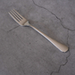 Stainless steel dining essentials including spoon, fork and knife for contemporary table settings.