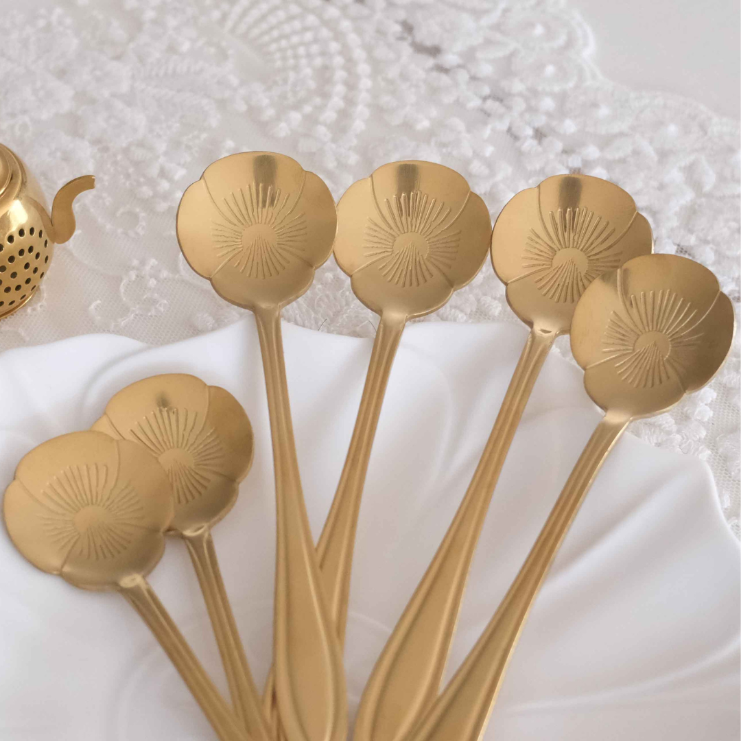 Gold dessert spoon set with floral engraved detailing