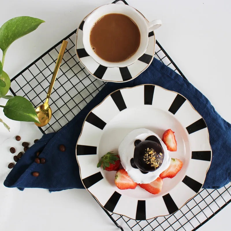 Elegant black and white striped tea cup and saucer collection with gold accents in luxury gift packaging