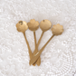 Set of designer floral spoons with intricately carved blossom-shaped bowls and sleek handles.
