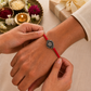 Sister tying spirtual rakhi to brother