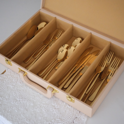 30-piece cutlery collection neatly arranged inside a beige storage case   