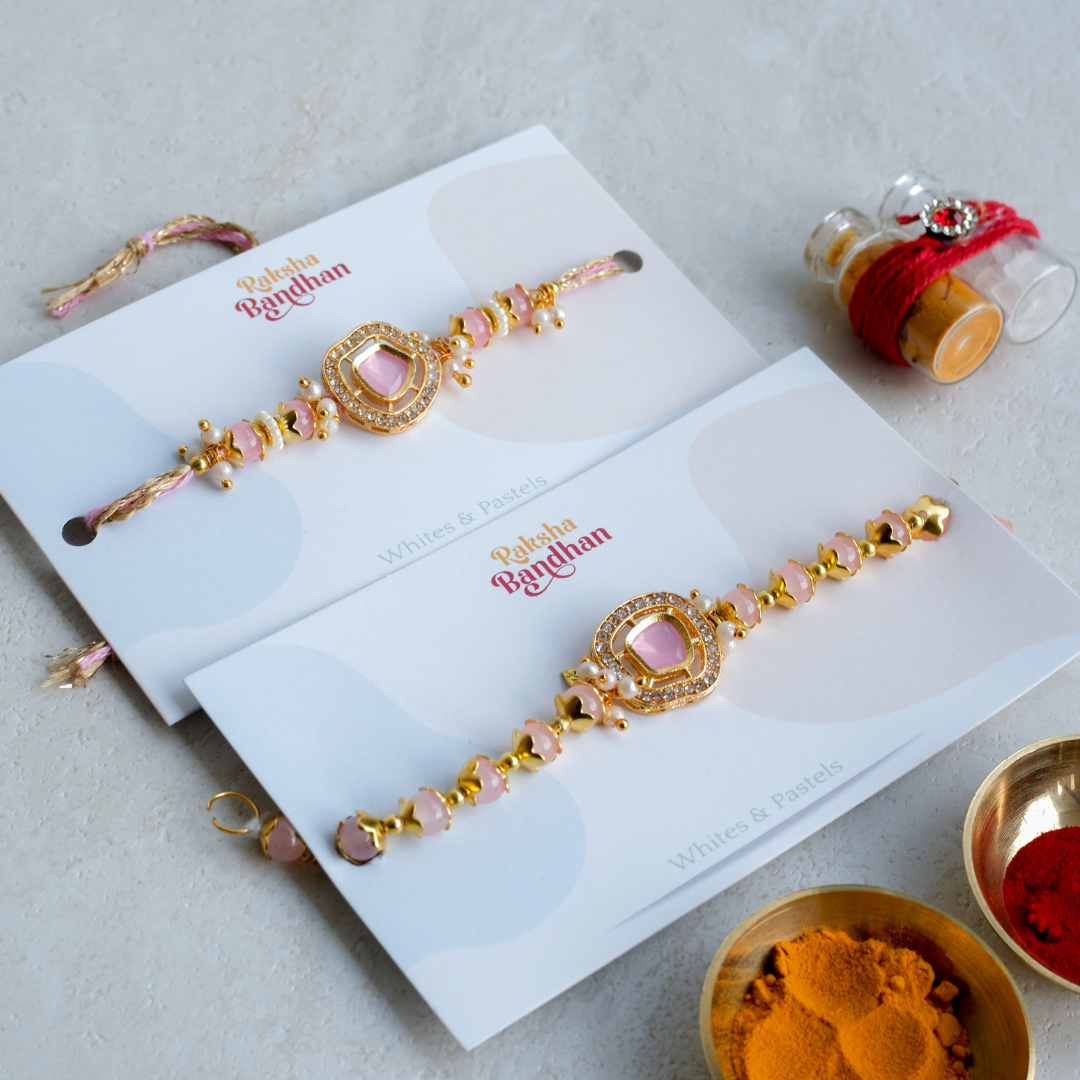 Premium pink crystal Bhai Bhabhi Rakhi set featuring a designer Rakhi, matching Lumba Rakhi, gold-tone accents and handcrafted beadwork for Raksha Bandhan.