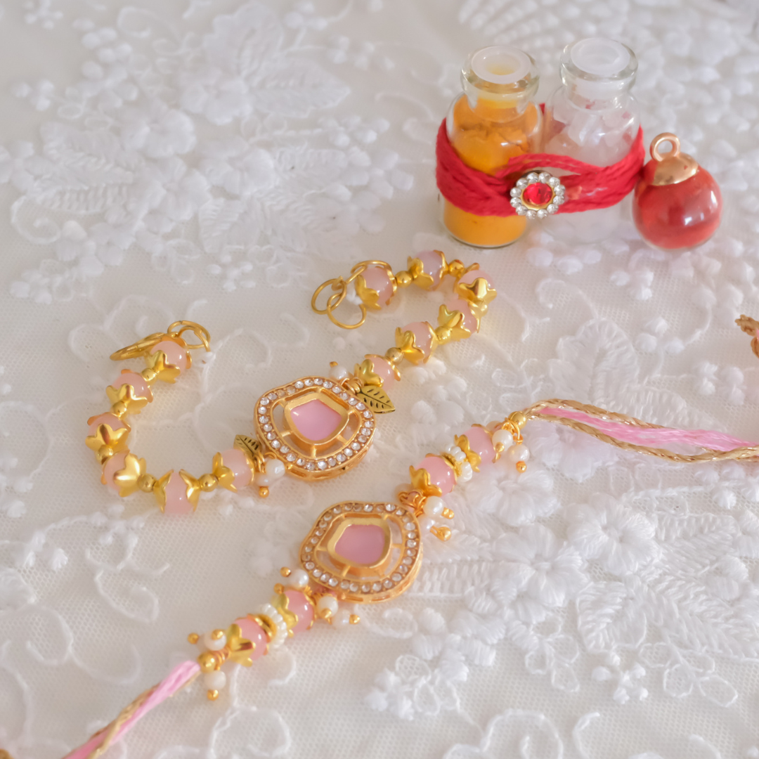 Luxury handcrafted pink crystal Rakhi set with matching Bhai and Lumba Rakhi, embellished with zircon stones, pearls and gold detailing.