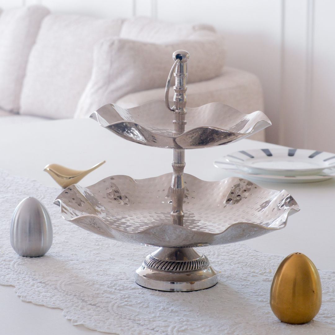 Modern tabletop serving stand with dual-tier design and sculptural detailing.