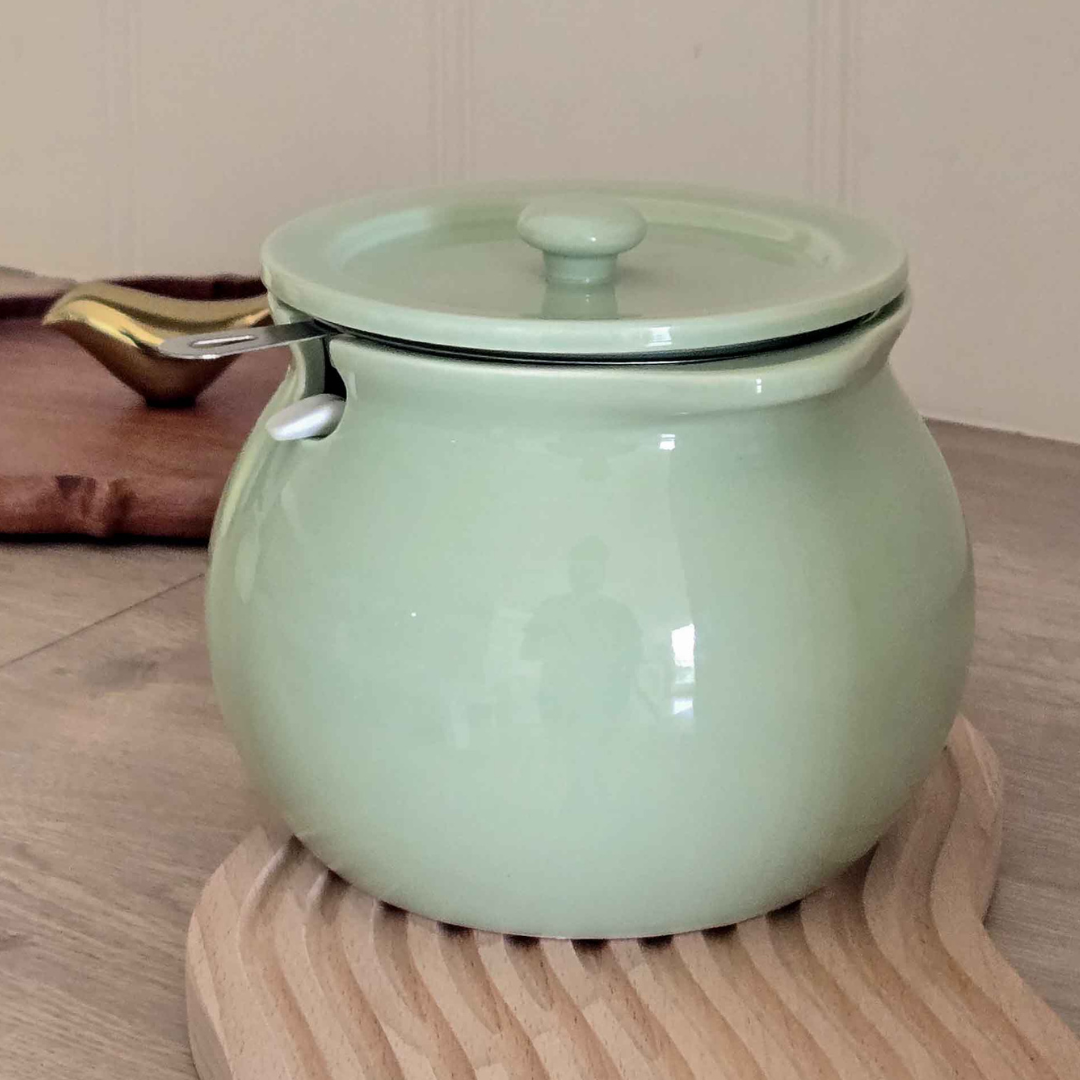 Minimalist ceramic countertop storage jar with airtight lid for organized kitchen shelves.