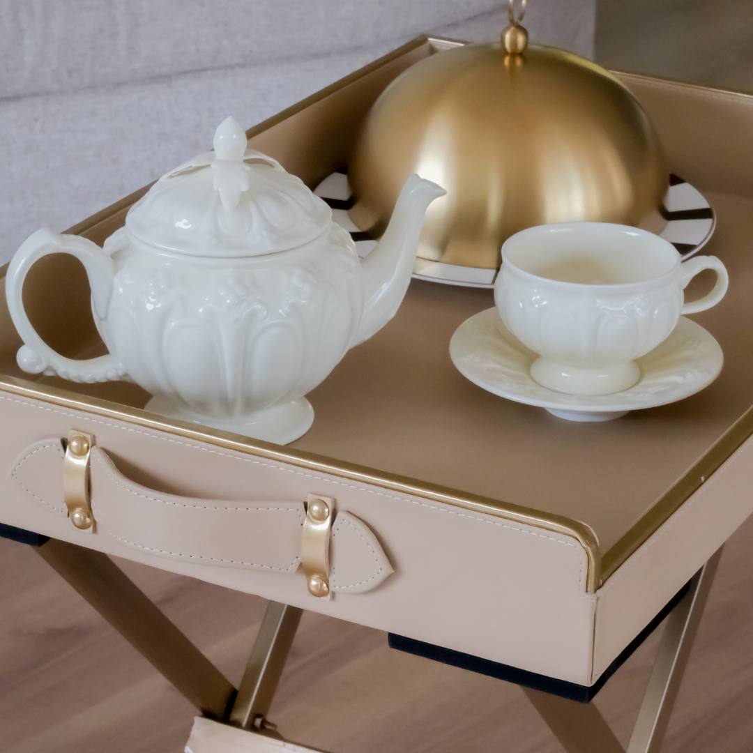 Front view of a beige folding butler tray featuring a removable serving tray and sturdy metal stand.