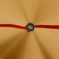 Premium handcrafted Pure Silver Om Rakhi with genuine silver centerpiece and adjustable red braided thread for Raksha Bandhan.