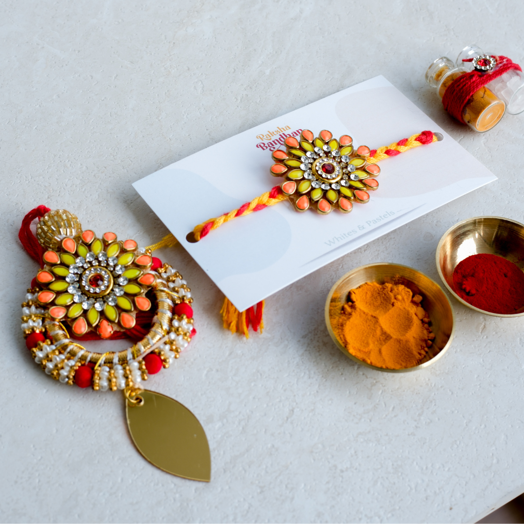 Traditional rakhi and lumba set crafted with kundan stones, pearls and handcrafted floral detailing.