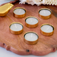Gold tea light candle holders creating a warm romantic candlelight dinner setup