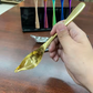 Gold stainless steel sauce drizzle spoon with spout for plating