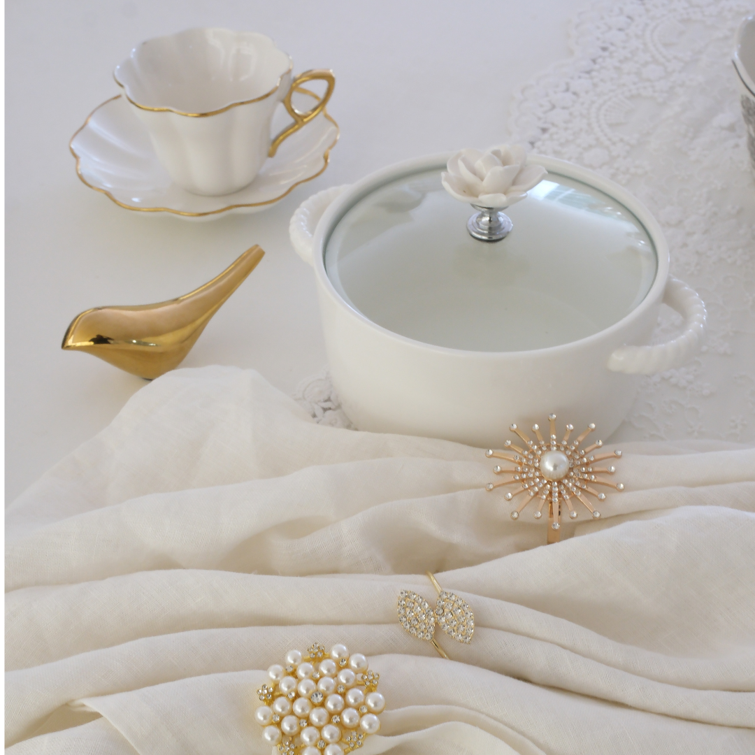 White ceramic serving bowl featuring a beautiful floral handle and glass lid