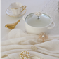 White ceramic serving bowl featuring a beautiful floral handle and glass lid