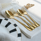 Luxury Gold cutlery placed on white napkin