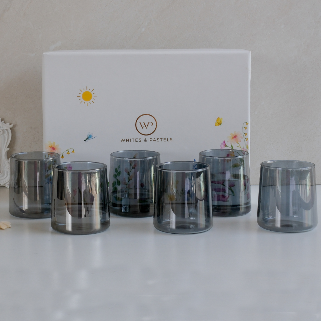 Set of six black glass tumblers displayed inside a premium floral gift box
