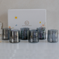 Set of six black glass tumblers displayed inside a premium floral gift box