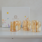 Set of six brown glass tumblers displayed inside a premium floral gift box
