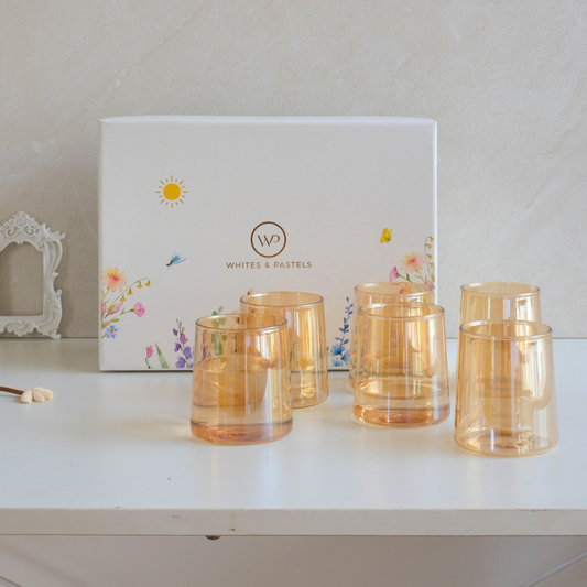 Set of six brown glass tumblers displayed inside a premium floral gift box